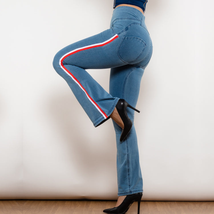 a woman wearing blue jeans and black heels