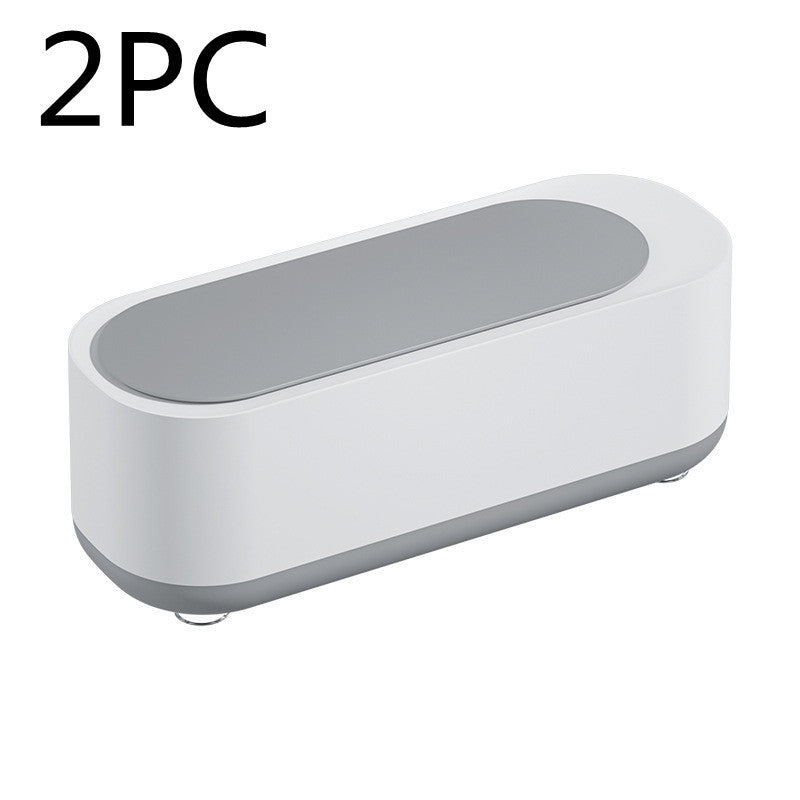 a white rectangular object with a grey oval lid