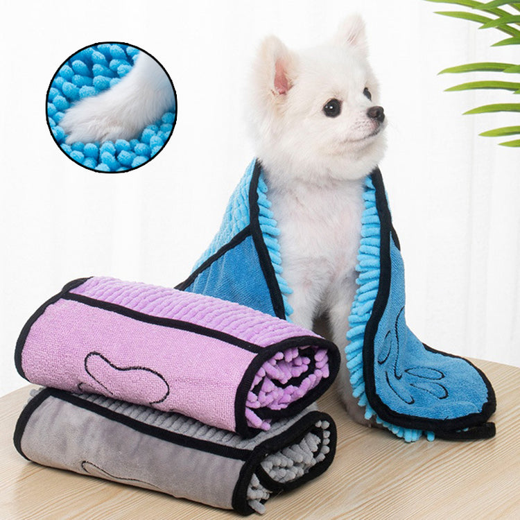 a dog sitting on a table with a blanket