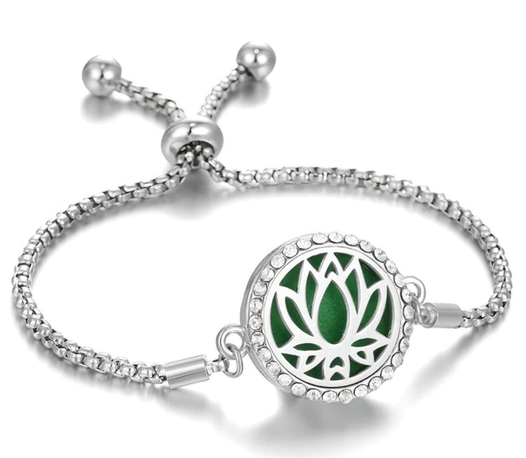 a silver bracelet with a green flower
