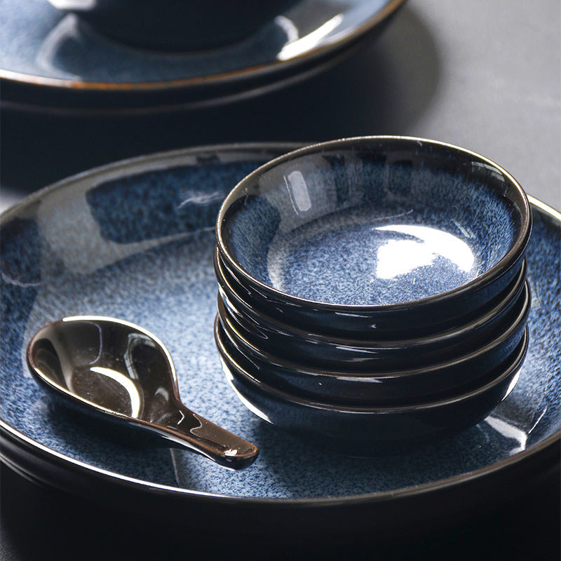 a stack of bowls and a spoon on a plate