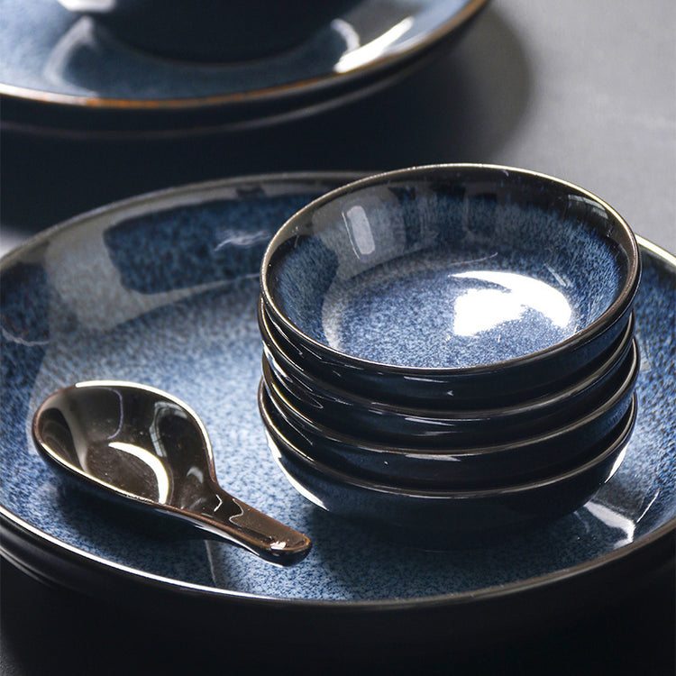 a stack of bowls and a spoon on a plate