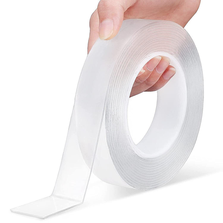 a hand holding a roll of clear tape