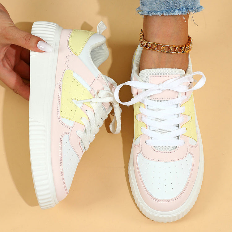 a person holding a pair of shoes