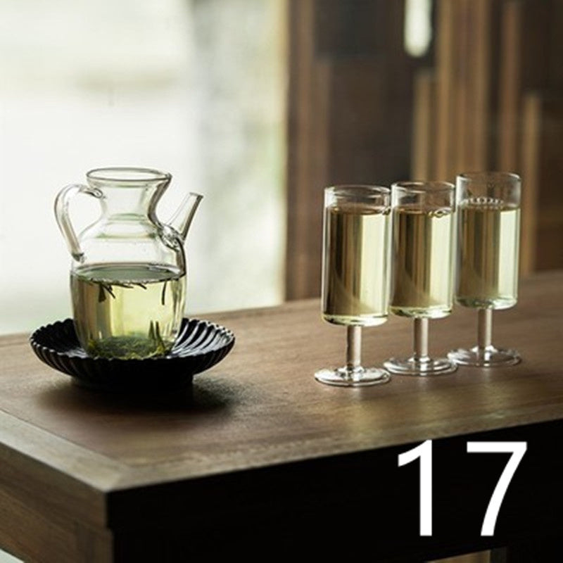 a glass pitcher and glasses of liquid on a table