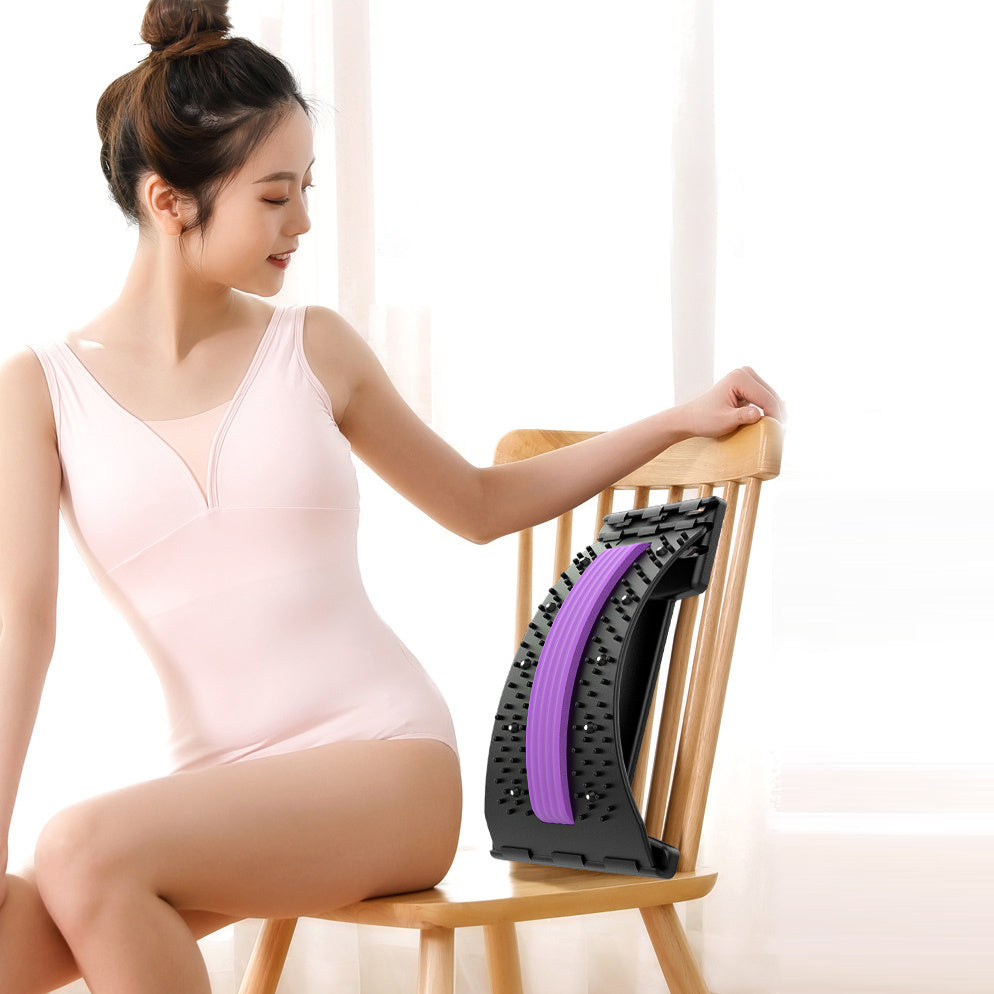 a woman sitting on a chair with a massager