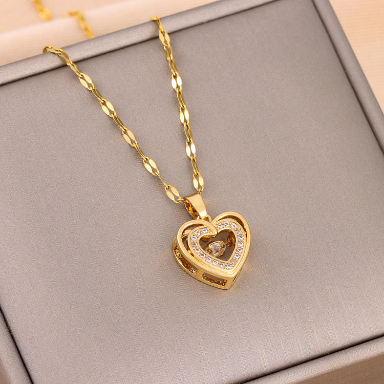 a gold heart necklace on a chain