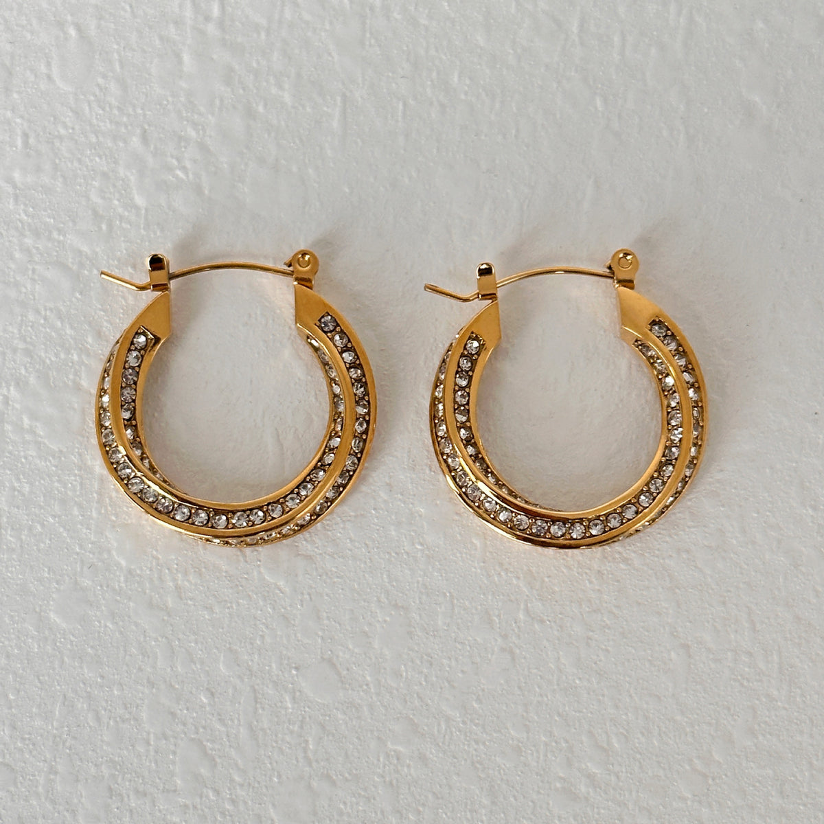 a pair of gold hoop earrings