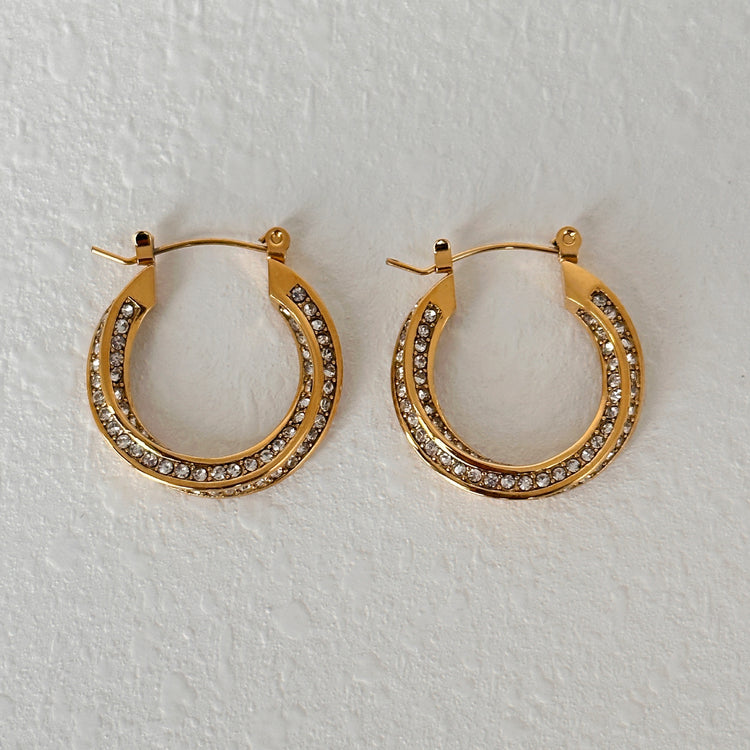 a pair of gold hoop earrings