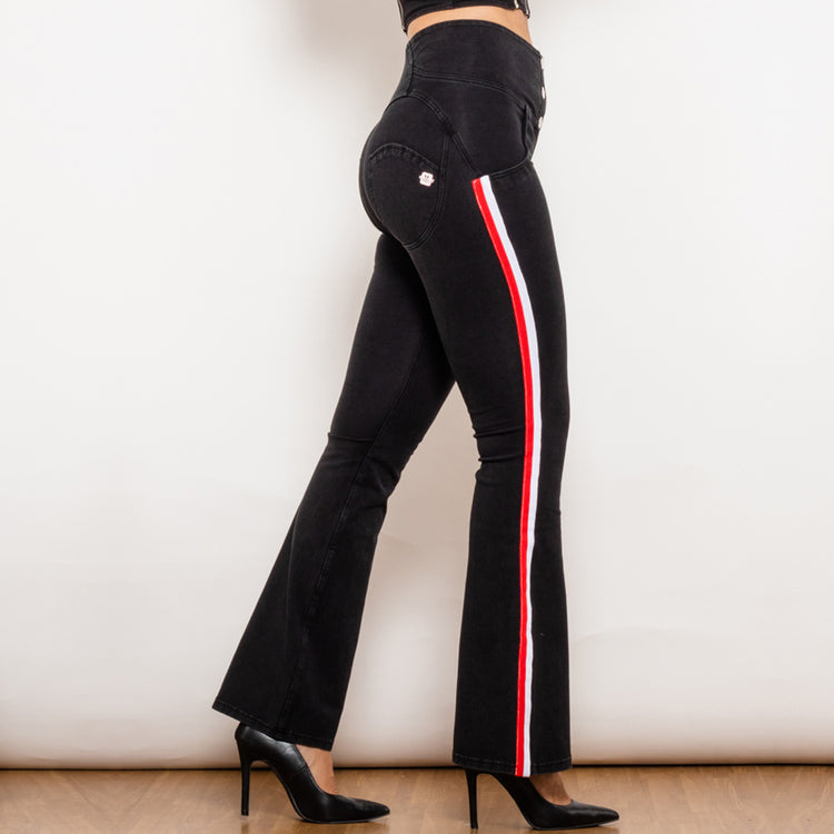 a woman wearing black pants with red and white stripes
