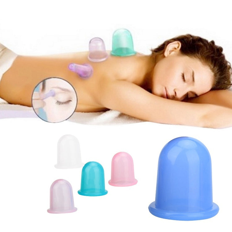 a woman lying down with cupping cups on her back