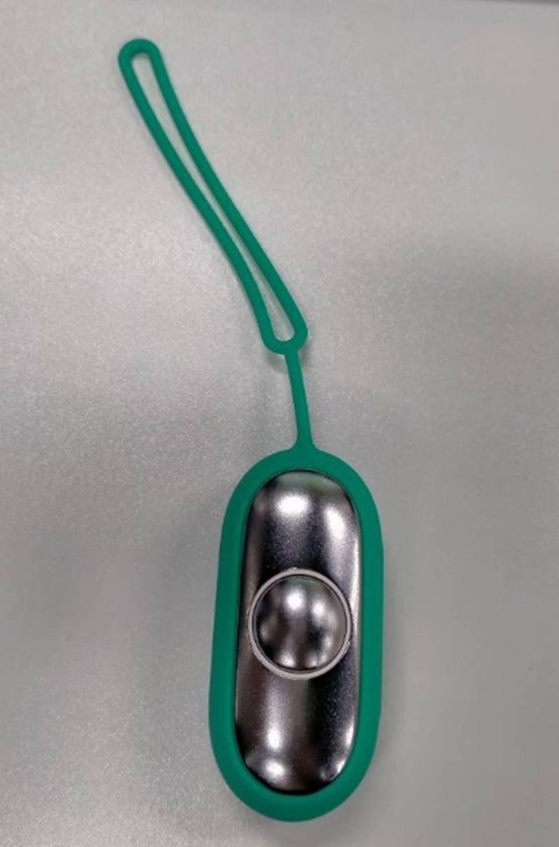 a green and silver object with a rubber band