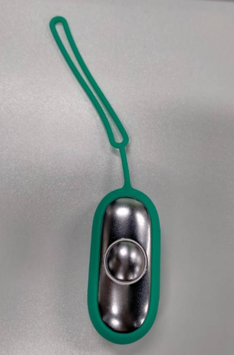 a green and silver object with a rubber band
