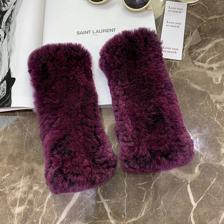 a pair of purple furry slippers on a marble surface