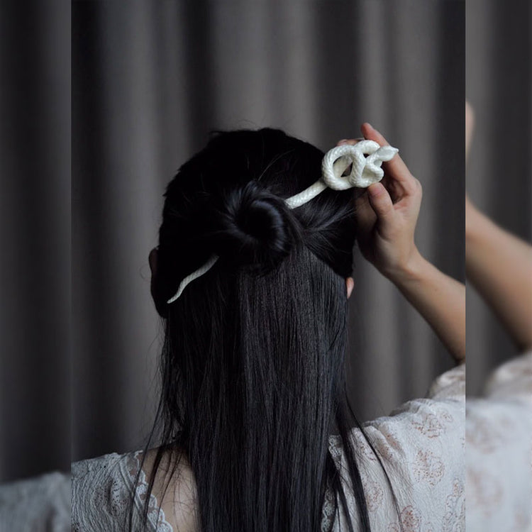 a woman with a white object in her hair