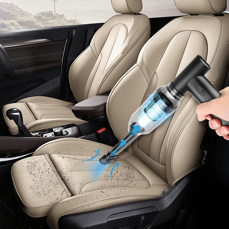 a person holding a vacuum cleaner in front of a car