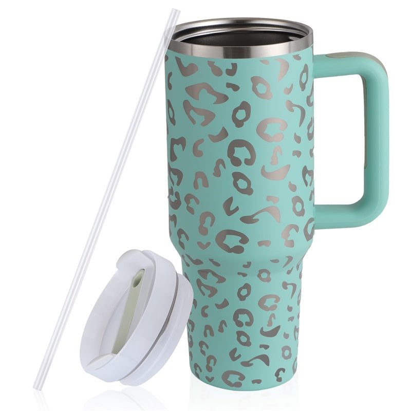 a teal and silver leopard print coffee mug with a straw