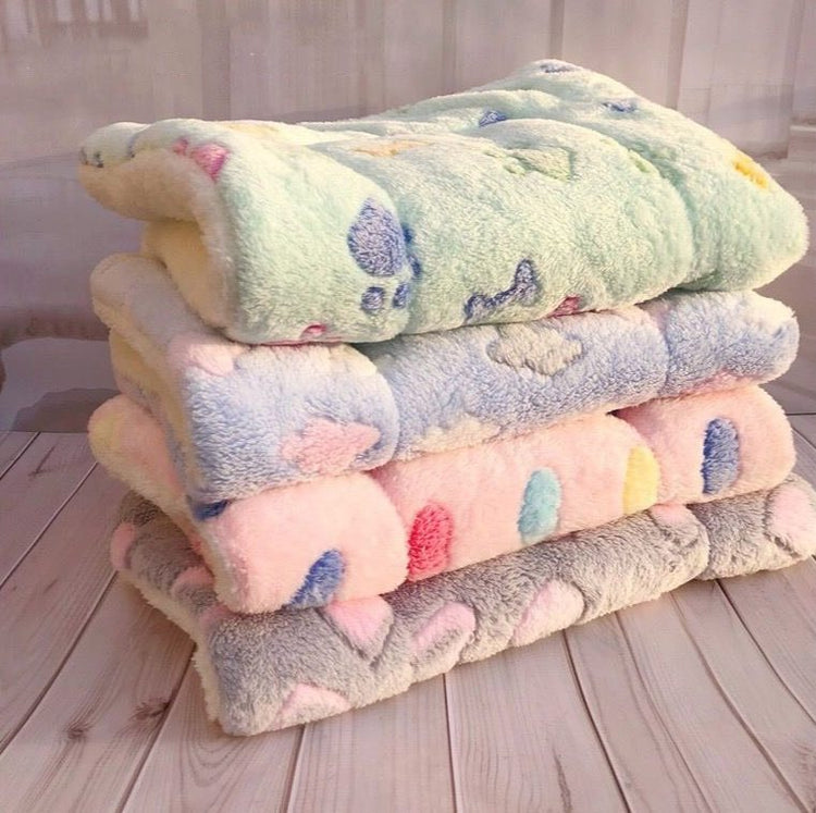 a stack of blankets on a wood surface