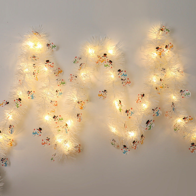 a white string of lights on a wall