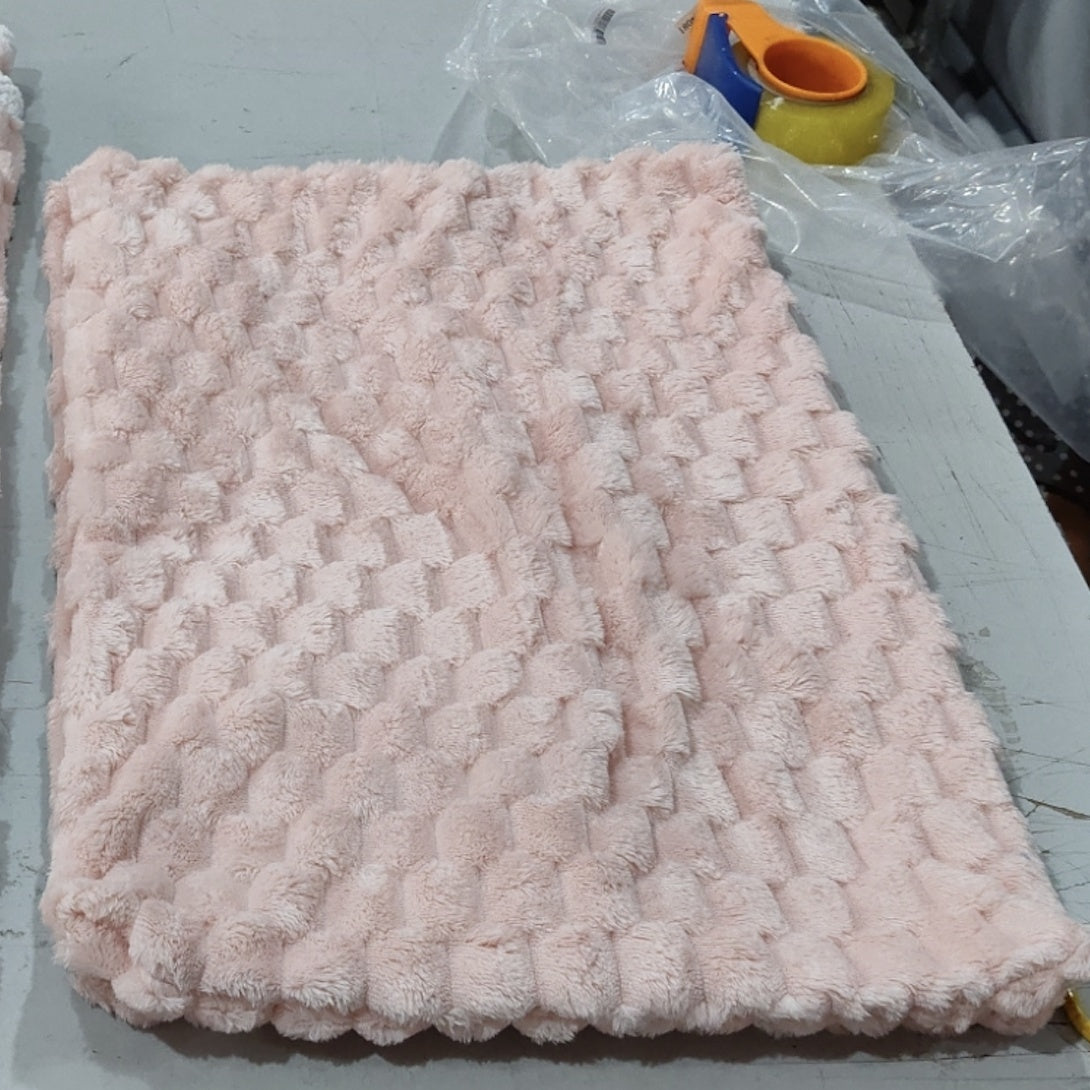 a pink blanket on a table