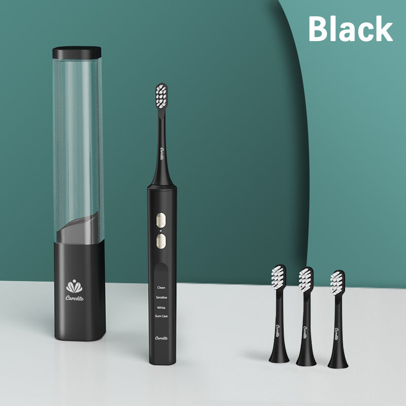 a black electric toothbrush next to several black toothbrushes