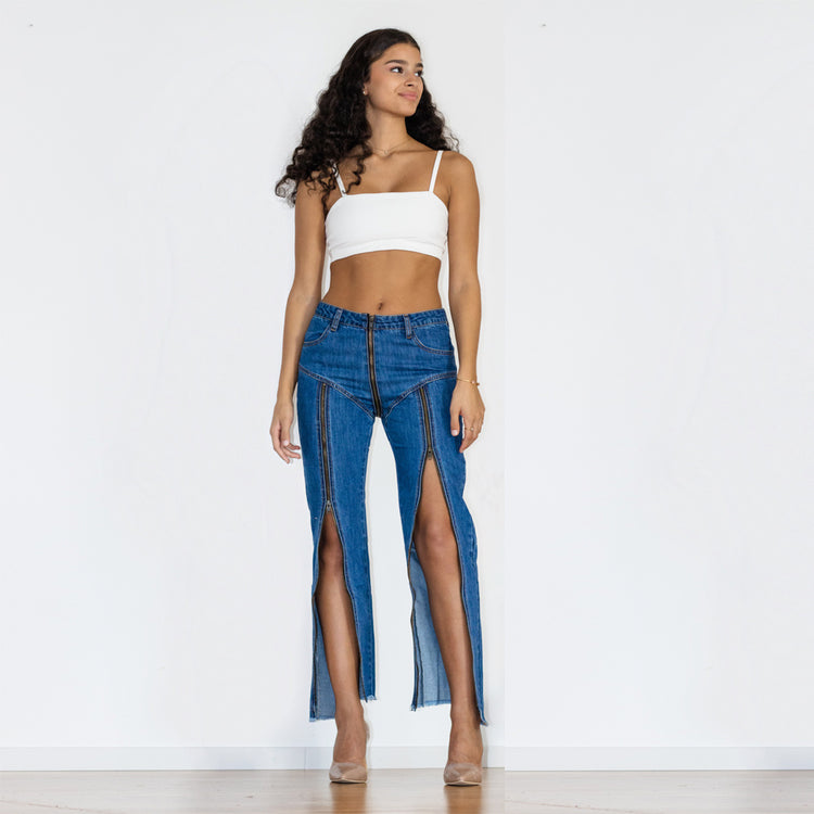 a woman in a white top and blue jeans