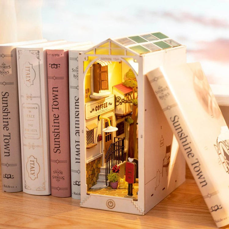 a book with a miniature house and a book on a table