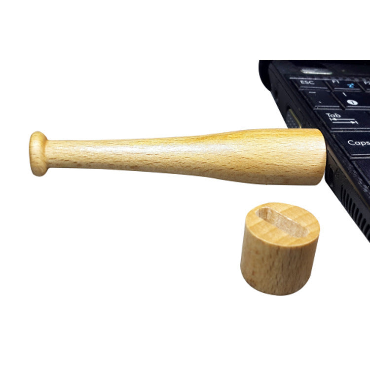 a wooden bat next to a laptop