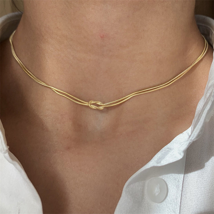a person wearing a gold necklace