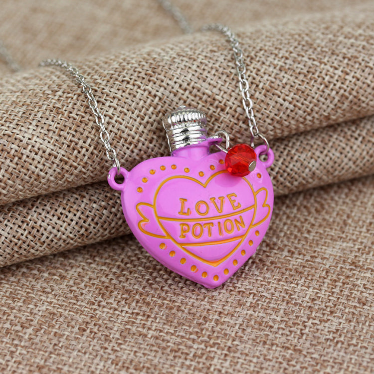 a pink heart shaped necklace with a red gem on a chain