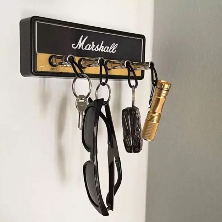 a key holder with keys and sunglasses on a wall