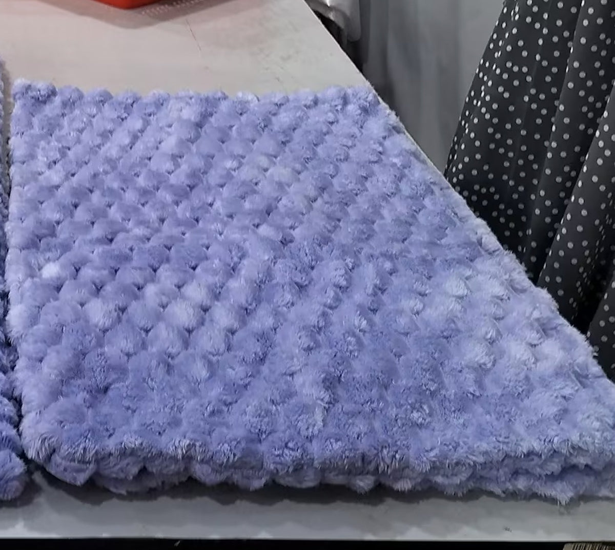 a purple fluffy blanket on a table