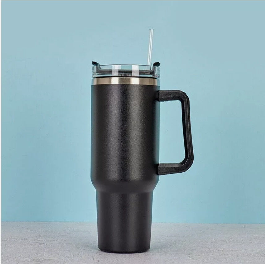 a black and gold travel mug with a straw