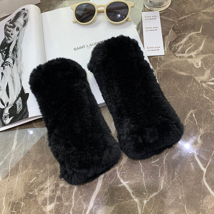 a pair of fur slippers on a table
