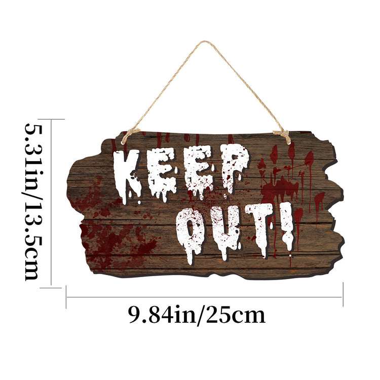 a wooden sign with white text and blood stains