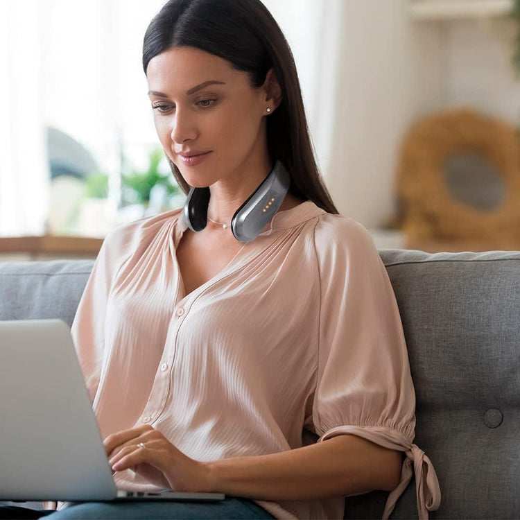 a woman sitting on a couch using a laptop