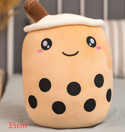 a stuffed animal with a face and black dots