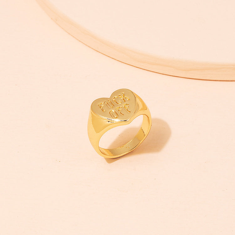 a gold ring with a heart on it