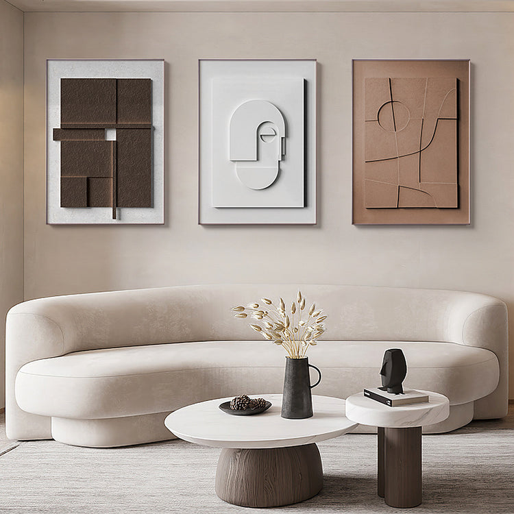 a white couch with a vase of flowers on a coffee table