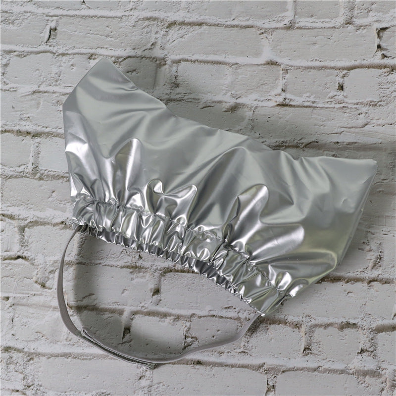 a silver hat on a brick wall