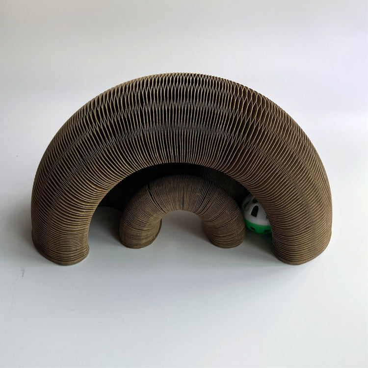 a cardboard arch with a ball inside