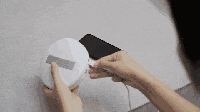 a person using a device to remove the battery