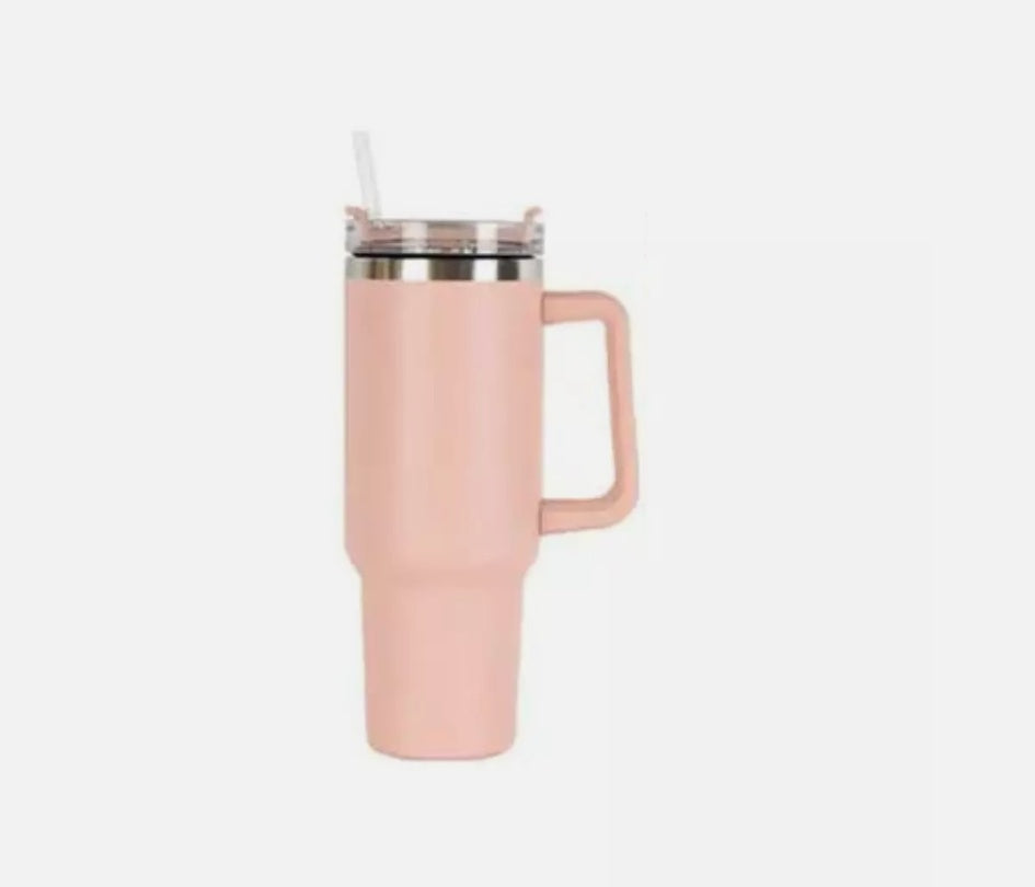 a pink mug with a straw
