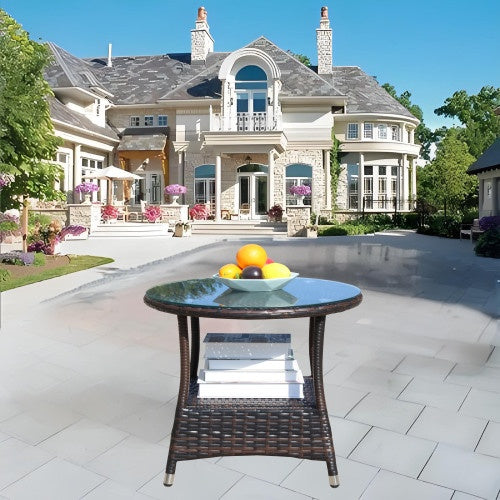 a table with fruit on it in front of a large house