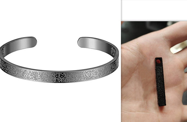 a silver bracelet with engraved patterns
