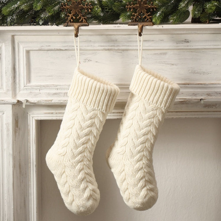 a pair of white knitted socks from a fireplace