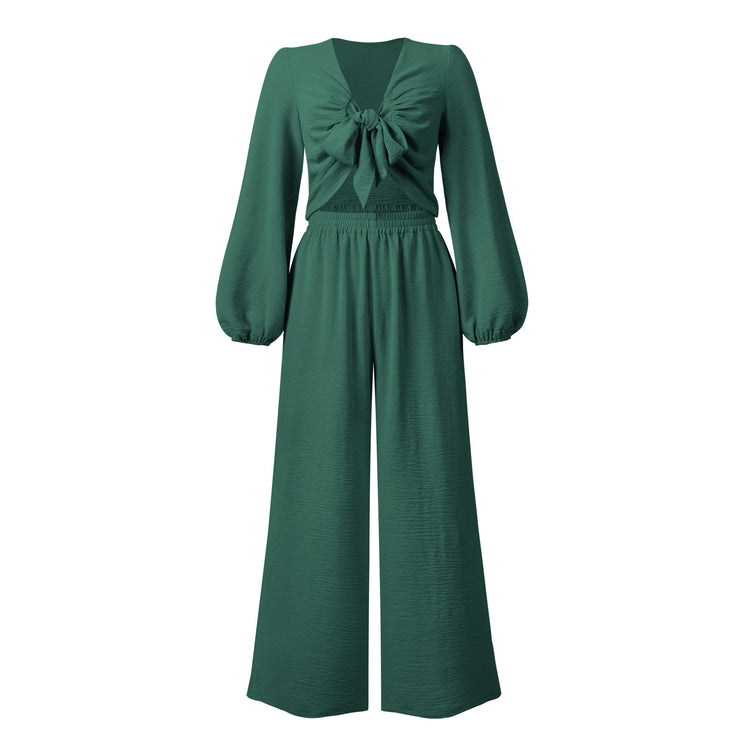 a green jumpsuit with a bow