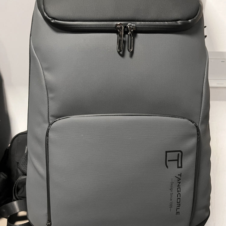 a grey backpack on a white surface