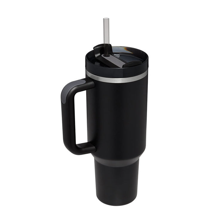 a black coffee mug with a straw