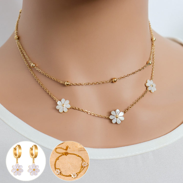 a necklace and earrings on a mannequin